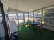 Sun Room with green carpet, table and chairs surrounded by lots of windows at 5211 Wisteria Cir, New Port Richey, FL 34653