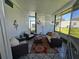 Bright and airy sunroom with comfortable seating and decorative accents at 5211 Wisteria Cir, New Port Richey, FL 34653