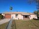 Cozy single-Gathering house with a fenced front yard, palm tree, and covered entry porch at 6110 Belspring Ave, Spring Hill, FL 34608