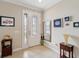 Welcoming foyer with tile floors, neutral walls, and glass-paneled front door and sidelight at 636 Tierra Dr, Spring Hill, FL 34609