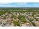 Birds-eye-view of a leafy neighborhood with houses nestled under trees and blue skies above; an ideal home location at 6433 Murray Hill Dr, Tampa, FL 33615