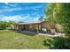 Charming backyard patio with lush green lawn and comfortable seating area for outdoor relaxation and entertaining at 6433 Murray Hill Dr, Tampa, FL 33615