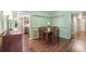 The dining room features hardwood floors, decorative green wall trim, and a wooden dining table set at 6433 Murray Hill Dr, Tampa, FL 33615