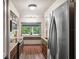 Bright kitchen with a window view, wooden cabinets, stainless steel appliances, and modern fixtures at 6433 Murray Hill Dr, Tampa, FL 33615