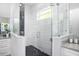 Modern bathroom with a glass-enclosed shower, black honeycomb tile floor, and granite countertop at 6514 Grapewood Rd, Spring Hill, FL 34609
