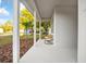 Inviting front porch with white columns and cozy wicker chairs for relaxing outdoors at 6514 Grapewood Rd, Spring Hill, FL 34609