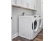 Laundry room with upper cabinets, a washing machine, and a dryer at 6514 Grapewood Rd, Spring Hill, FL 34609