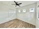 Bedroom featuring light wood floors, a closet, and a modern ceiling fan at 6526 1St S Ave, St Petersburg, FL 33707