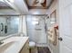 Neat and well-lit bathroom featuring a walk-in shower, vanity with sink, and tiled floors at 7215 121St Ter, Largo, FL 33773