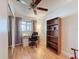 This bedroom provides a workspace with a desk, bookshelf, and a window letting in natural light, with a ceiling fan at 7215 121St Ter, Largo, FL 33773