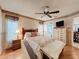 Comfortable bedroom with an en suite bathroom, dresser, and a ceiling fan with wooden blades at 7215 121St Ter, Largo, FL 33773