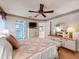 Bright bedroom with ensuite bathroom, and a dresser with a large round mirror at 7215 121St Ter, Largo, FL 33773
