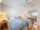 This inviting bedroom features two beds, ceiling fan, and mirrored closet doors, creating a comfortable and functional space at 7215 121St Ter, Largo, FL 33773
