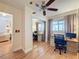 This bedroom provides a workspace with a desk, bookshelf, and a window letting in natural light, with a ceiling fan at 7215 121St Ter, Largo, FL 33773