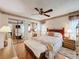 Charming bedroom featuring ceiling fan, mirrored closet doors, and a cozy bed with a colorful quilt at 7215 121St Ter, Largo, FL 33773