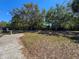 An open-air dog park with mature shade trees offers space for pets to roam freely at 7215 121St Ter, Largo, FL 33773