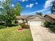 Well-maintained single-story home with a two-car garage and lush front lawn at 7215 121St Ter, Largo, FL 33773