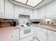 Detailed view of the stove and counter area in the light and bright kitchen at 7215 121St Ter, Largo, FL 33773