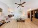 Inviting living room featuring a ceiling fan, cozy furniture, and views into the dining area at 7215 121St Ter, Largo, FL 33773