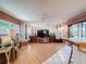 Open living room with ceiling fan, neutral furniture, wood flooring, and sliding glass doors at 7215 121St Ter, Largo, FL 33773