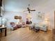 Bright living room with laminate floors, ceiling fan, and access to the dining area at 7215 121St Ter, Largo, FL 33773
