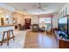 Living room showcasing an open floor plan with wood and tile flooring, kitchen and dining areas at 7215 121St Ter, Largo, FL 33773