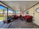 Inviting screened patio with brick flooring, comfortable seating, and a ceiling fan for outdoor relaxation at 7215 121St Ter, Largo, FL 33773