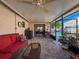 Relaxing covered patio with ceiling fan, brick flooring, and access to the beautiful backyard and pool at 7215 121St Ter, Largo, FL 33773