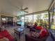 Inviting covered patio with comfortable seating overlooking the sparkling pool and landscaped backyard at 7215 121St Ter, Largo, FL 33773