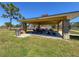 Outdoor picnic pavilion with tables, stone supports and mature landscaping at 7215 121St Ter, Largo, FL 33773