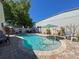 Refreshing in-ground pool with paver surround, sun umbrella, and chairs perfect for outdoor enjoyment at 7215 121St Ter, Largo, FL 33773