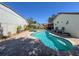 Sparkling pool surrounded by brick pavers, with seating and lush landscaping, creating a private backyard oasis at 7215 121St Ter, Largo, FL 33773