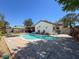 Sparkling pool surrounded by brick pavers, with seating and lush landscaping, creating a private backyard oasis at 7215 121St Ter, Largo, FL 33773