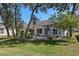 Backyard with paver patio, seating, landscaping, and mature shade trees at 7305 Sugarbush, Spring Hill, FL 34606