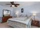 Comfortable bedroom with a large window, ceiling fan and dresser at 7305 Sugarbush, Spring Hill, FL 34606