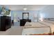 A large bedroom with a queen bed, bright walls and a TV on the wall at 7305 Sugarbush, Spring Hill, FL 34606