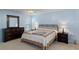 Large bedroom with comfortable queen bed, a ceiling fan and lots of storage with dressers and night stands at 7305 Sugarbush, Spring Hill, FL 34606