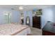 Bright, airy bedroom with a queen bed, open bathroom access and TV at 7305 Sugarbush, Spring Hill, FL 34606