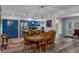 Dining area leading to kitchen with blue cabinets, offering space for Gathering meals and gatherings at 7305 Sugarbush, Spring Hill, FL 34606