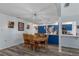 Open dining area with wood table and pendant lighting, adjoining a modern kitchen with blue cabinets at 7305 Sugarbush, Spring Hill, FL 34606