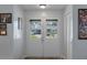 Charming entryway featuring double doors with grid windows showcasing the home's exterior and landscaping at 7305 Sugarbush, Spring Hill, FL 34606