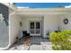 Inviting front porch with decorative accents, including chairs, lush greenery, and patterned concrete pathway at 7305 Sugarbush, Spring Hill, FL 34606
