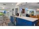Kitchen featuring blue cabinetry, stainless steel appliances, and a convenient breakfast bar area at 7305 Sugarbush, Spring Hill, FL 34606