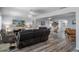 Spacious living room featuring modern flooring, comfortable seating, and a seamless open floorplan to the rest of the house at 7305 Sugarbush, Spring Hill, FL 34606