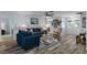 Bright, open living room with stylish furniture, hardwood floors, and a view of the front entrance at 7305 Sugarbush, Spring Hill, FL 34606