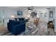 Bright, open living room featuring stylish furniture, hardwood floors, and ample natural light at 7305 Sugarbush, Spring Hill, FL 34606