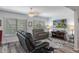 Comfortable living room features large windows, entertainment center, and leather seating for relaxed living at 7305 Sugarbush, Spring Hill, FL 34606