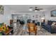 Bright, open living room with hardwood floors, comfortable seating, and views into dining area at 7305 Sugarbush, Spring Hill, FL 34606