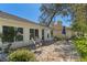 Paver patio with multiple seating areas including rocking chairs surrounded by greenery at 7305 Sugarbush, Spring Hill, FL 34606