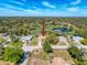 An aerial view shows the home in a residential neighborhood with a pond at 8367 Apple Orchard Rd, Spring Hill, FL 34608